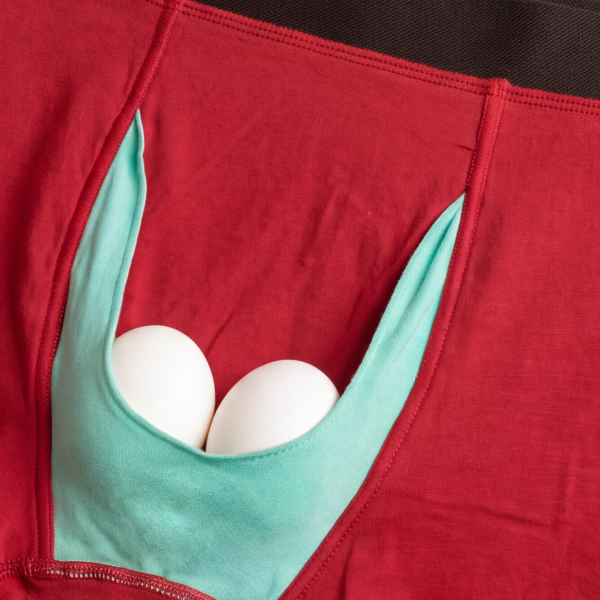Two eggs cradled in the mint-green Ball Hammock pouch of a pair of red boxer briefs